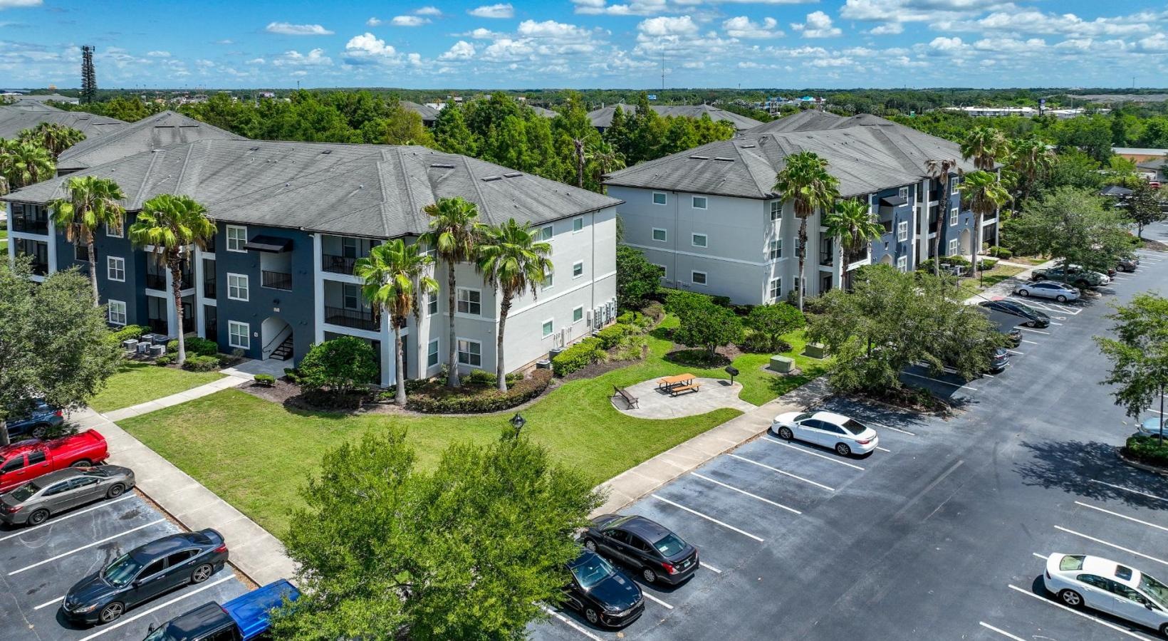 The essence of exceptional living a parking lot with cars and buildings along it