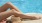 a person lying on a sundeck near a pool