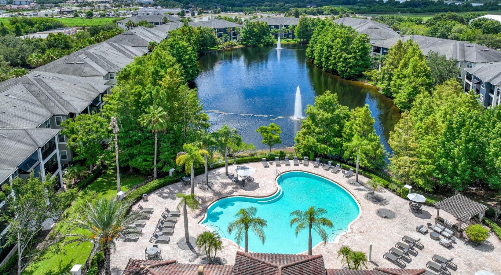 The essence of exceptional living a pool surrounded by trees and buildings