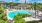 a pool surrounded by trees and a building