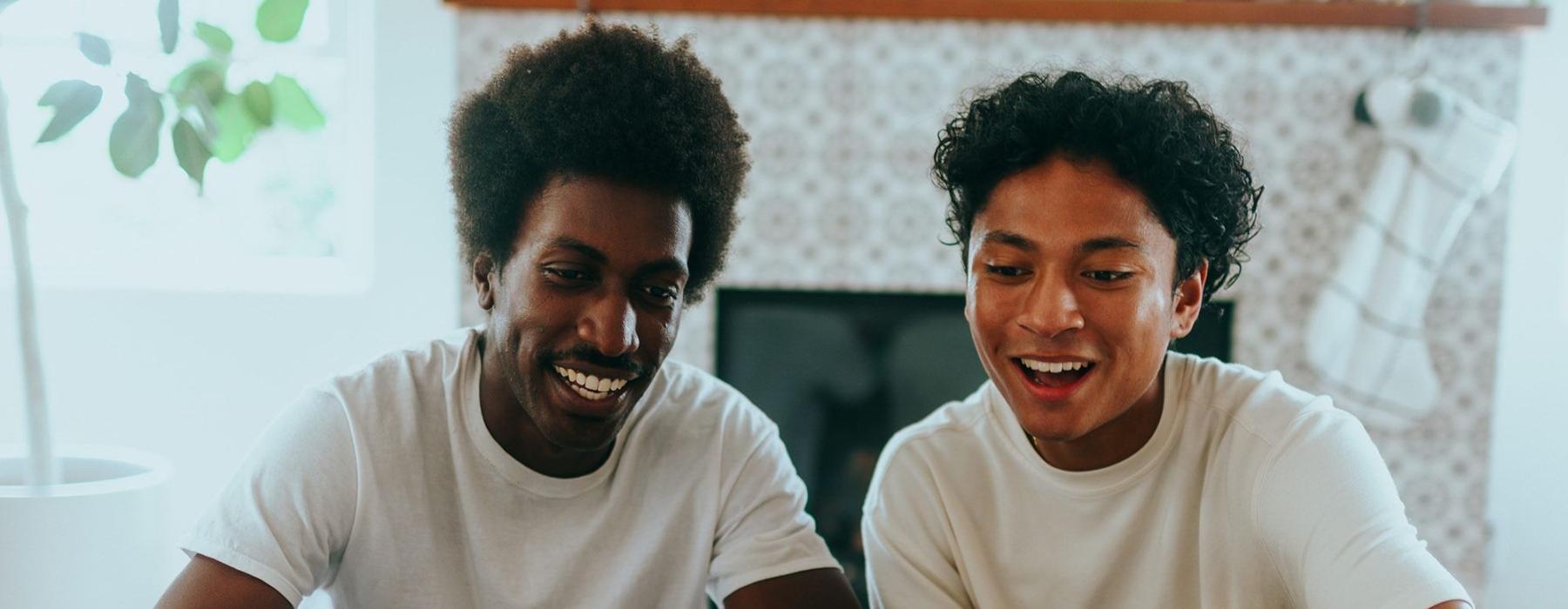 father and son sit together in living room