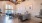 a large room with a wood floor and a chandelier