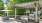a patio with a gazebo and chairs