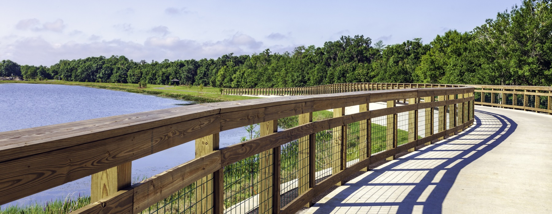 This concrete foot & bike path with protective wooden railings are part of the Fliorida Trails project. Here it parallels the shore of Shingle Creek within the Shinge Creek Park and Preserve in Kissimmee, Florida