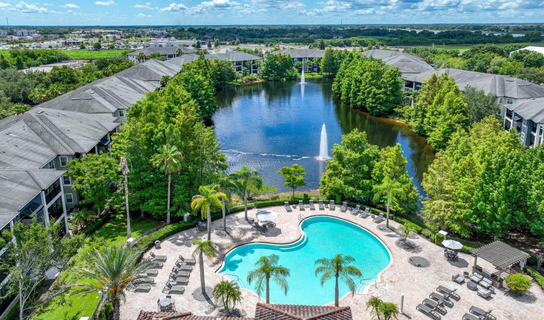 The essence of exceptional living a pool surrounded by trees and buildings