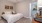 a bedroom with a bed and a fan
