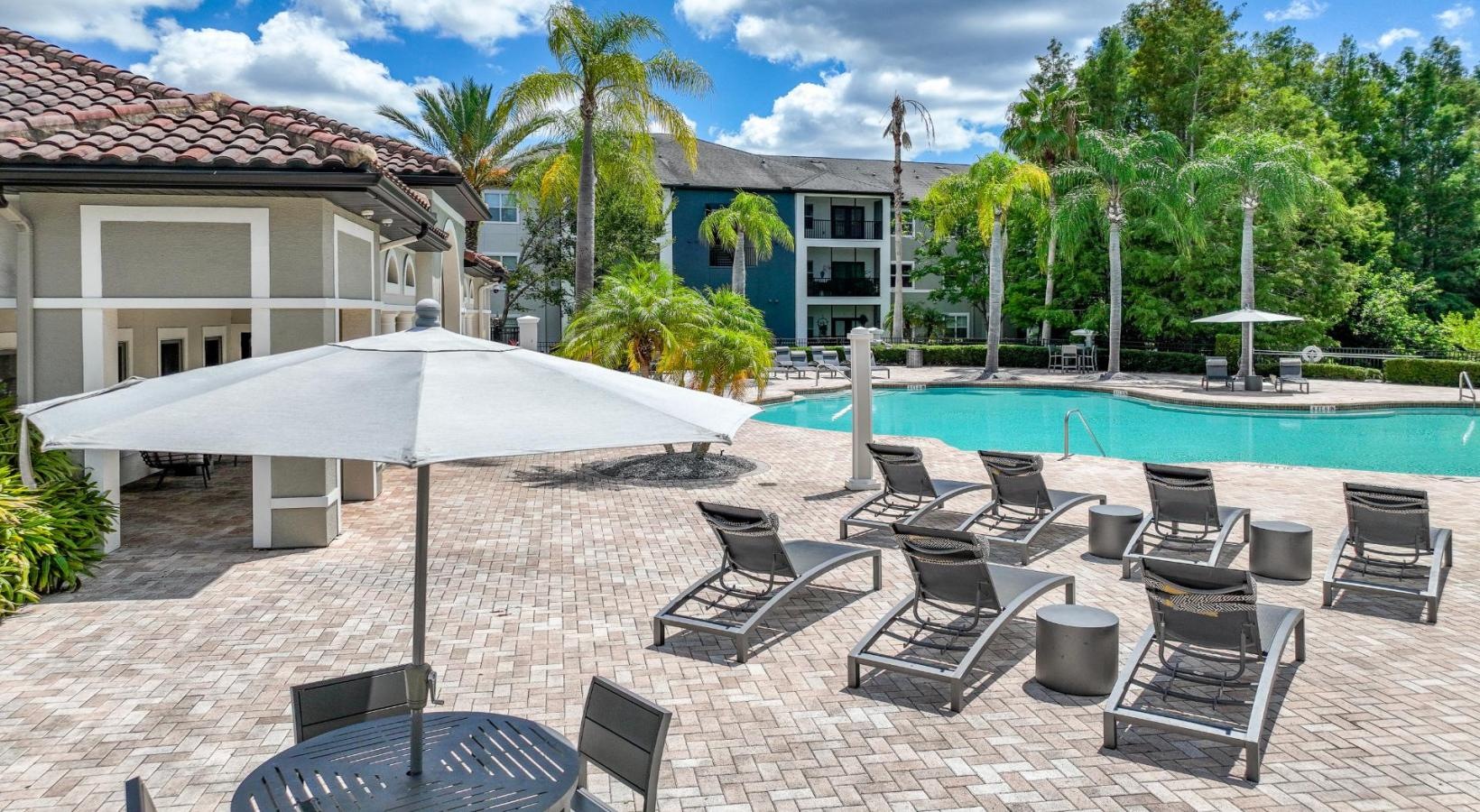Find your perfect fit at Verano a pool with chairs and umbrellas